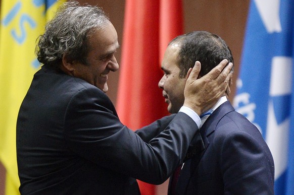 epa04774648 Prince Prinz Ali bin al-Hussein (R) with UEFA President Michel Platini (L) after announcing his withdrawal during the 65th FIFA Congress at the Hallenstadion in Zurich, Switzerland, 29 May ...