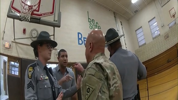 This photo, provided by Ohio State Highway Patrol, shows police bodycam footage from NewsNation correspondent Evan Lambert talking Wednesday, Feb. 8, 2023, with the Ohio National Guard leader in…