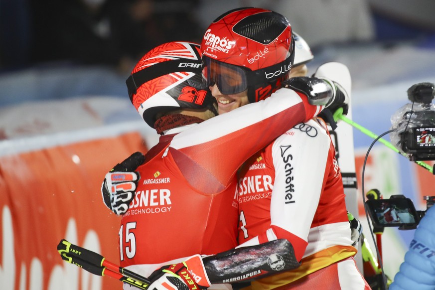Austria&#039;s Christian Hirschbuehl, left, winner of an alpine ski, men&#039;s World Cup parallel event, hugs second-placed Austria&#039;s Dominik Raschner, in Lech/Zuers, Austria, Sunday, Nov. 14, 2 ...