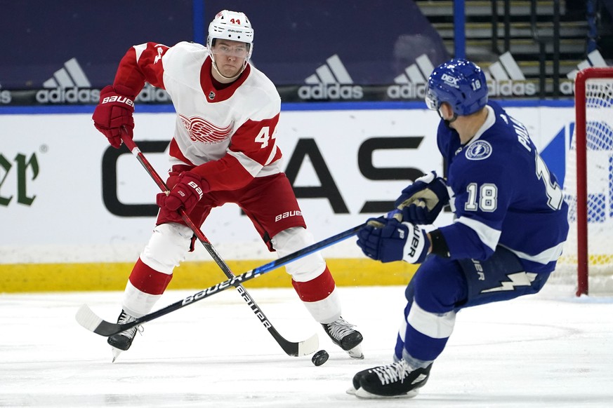 Detroit Red Wings defenseman Christian Djoos (44) carries the puck in front of Tampa Bay Lightning left wing Ondrej Palat (18) during the third period of an NHL hockey game Wednesday, Feb. 3, 2021, in ...
