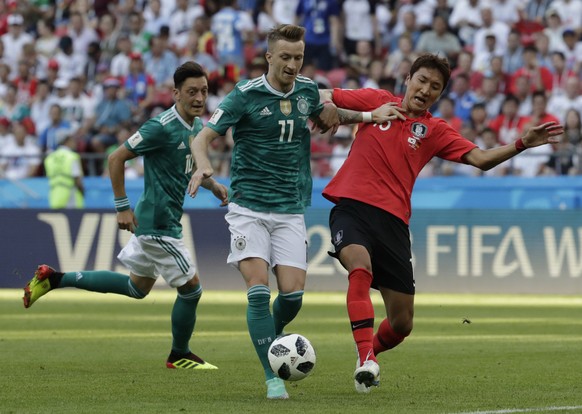 Germany&#039;s Marco Reus challenges for the ball South Korea&#039;s Jung Woo-young, right, during the group F match between South Korea and Germany, at the 2018 soccer World Cup in the Kazan Arena in ...