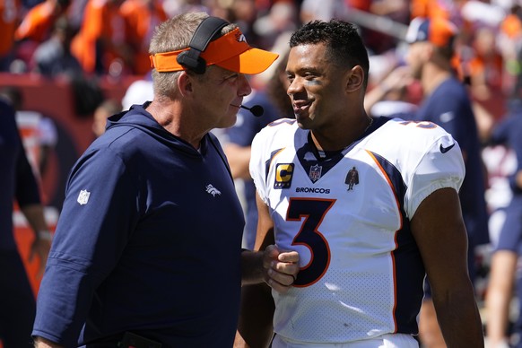 Denver Broncos head coach Sean Payton talks with quarterback Russell Wilson (3) in the first half of an NFL football game against the Washington Commanders, Sunday, Sept. 17, 2023, in Denver. (AP Phot ...