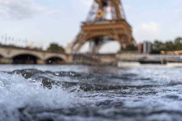 Waves crash along the banks of the Seine River in front of the Eiffel Tower during the 2024 Summer Olympics, Monday, July 29, 2024, in Paris. As the Olympics continue in Paris, the Seine River&#039;s  ...