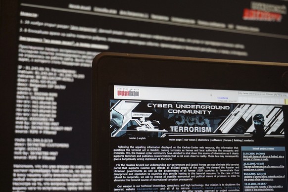 In this July 24, 2017 photo, archived versions of two Russian anti-terrorism websites on a computer screen are photographed, in Paris. The now-defunct websites were the brainchild of alleged hacker Py ...