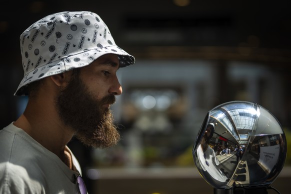FILE - Daniel Kertusha, 21, has his eyes scanned by an orb at a Worldcoin registration point in Barcelona, Spain, Friday, Aug. 4, 2023. Spain?s privacy watchdog has ordered for Worldcoin to cease its  ...