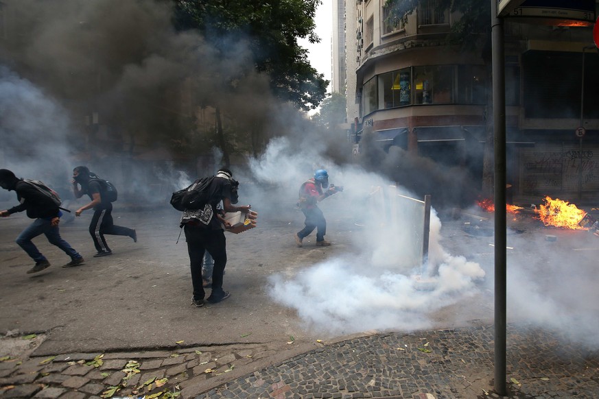 epa05781794 Protesters face off with police during a demonstration, in Rio de Janeiro, Brazil, 09 February 2017. The protesters are demonstrating against the governments austerity measures including  ...