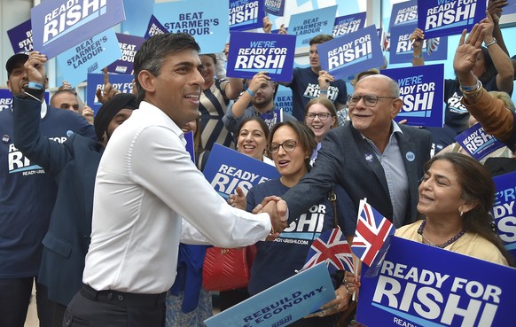 FILE - Rishi Sunak meets supporters as he arrives to attend a Conservative Party leadership election hustings at the NEC, Birmingham, England, Tuesday, Aug. 23, 2022. After weeks of waiting, Britain w ...
