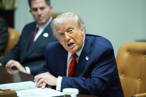 Sitting next to founder and CEO of Dell, Michael Dell, left, President Donald Trump speaks during a roundtable discussion with business leaders in the Roosevelt Room of the White House, Wednesday, Dec ...