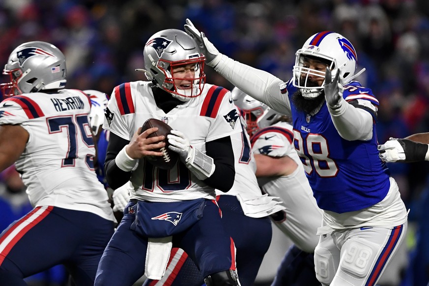 New England Patriots quarterback Mac Jones (10) is sacked by Buffalo Bills defensive tackle Star Lotulelei (98) during the first half of an NFL wild-card playoff football game, Saturday, Jan. 15, 2022 ...