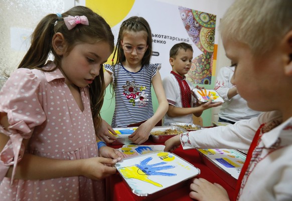 epa09982418 Local children make drawings on covers of lunch boxes, to be handed to Ukrainian servicemen, in Odesa, Ukraine, 28 May 2022. On 24 February, Russian troops invaded Ukrainian territory star ...