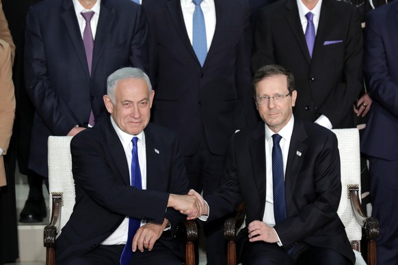 epa10381794 Israeli Prime Minister Benjamin Netanyahu (L) poses with Israeli President Isaac Herzog during the traditional group photo with Israel's new government, at the President's Residence...