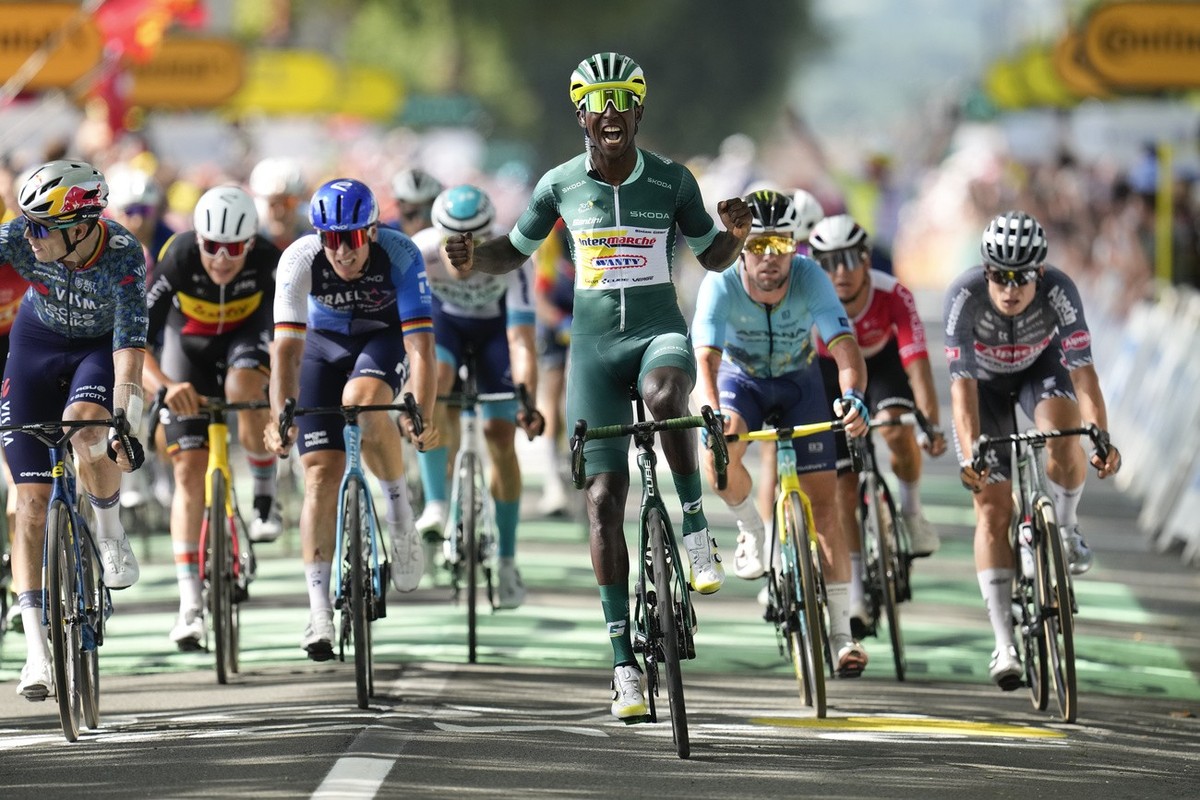 Eritrea's Biniam Girmay, wearing the best sprinter's green jersey, celebrates as he crosses the finish line ahead of Belgium's Wout van Aert, far left, Belgium's Arnaud de Lie, sec ...
