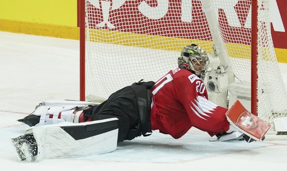 Goalie Reto Berra of Switzerland saves the goal during the Ice Hockey World Championship group A match between the Switzerland and Slovakia at the Olympic Sports Center in Riga, Latvia, Thursday, May  ...