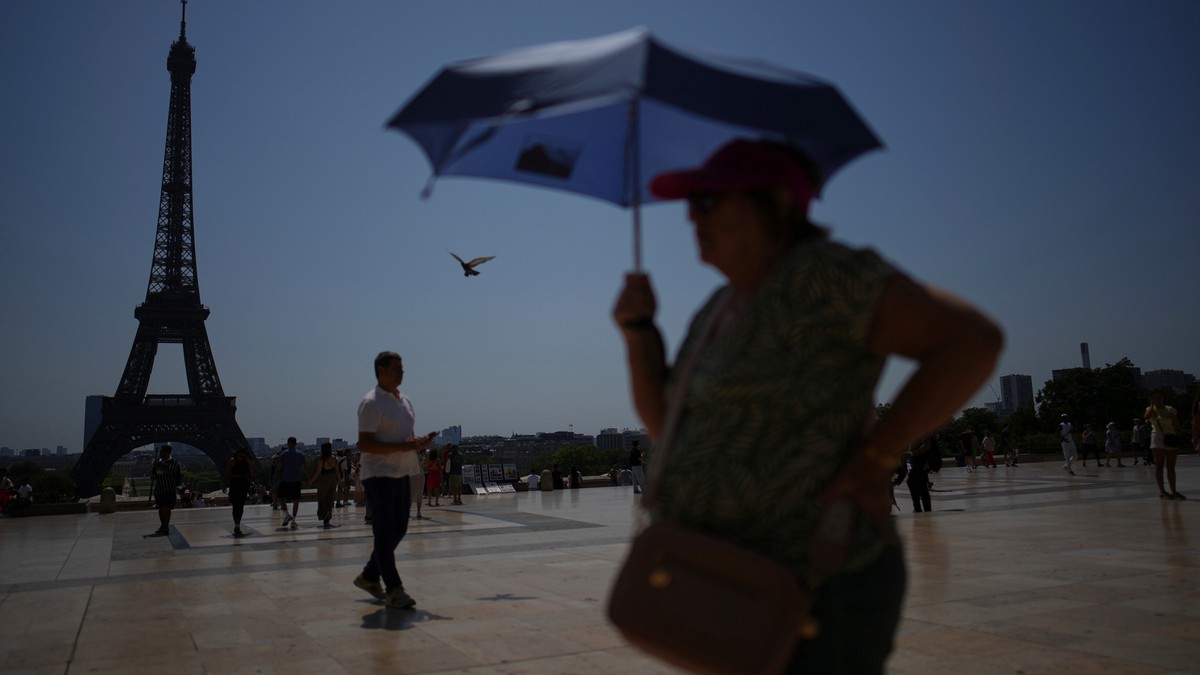 FILE - People walk at Trocadero plaza near the Eiffel Tower during a heat wave July 2, 2025, in Paris. (AP Photo/Christophe Ena, File)
Europe Heat Deaths