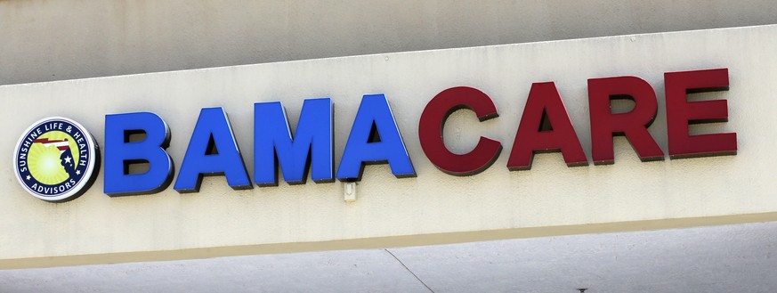 File- This May 11, 2017, file photo shows an Obamacare sign being displayed on the storefront of an insurance agency in Hialeah, Fla. A conservative federal judge in Texas on Friday, Dec. 14, 2018, ru ...