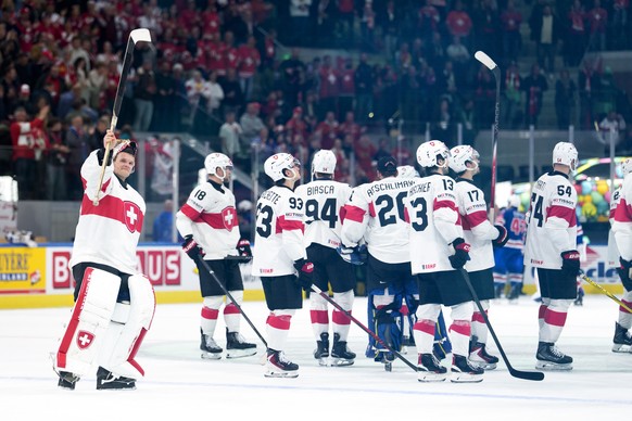 Switzerland's goaltender Leonardo Genoni, left, celebrates the victory after the 2026 IIHF Men's Ice Hockey World Championship preliminary round group A game between United States and Switze ...