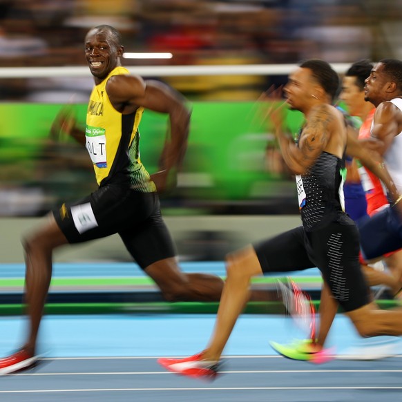 2016 Rio Olympics - Athletics - Semifinal - Men&#039;s 100m Semifinals - Olympic Stadium - Rio de Janeiro, Brazil - 14/08/2016. Usain Bolt (JAM) of Jamaica looks at Andre De Grasse (CAN) of Canada as  ...