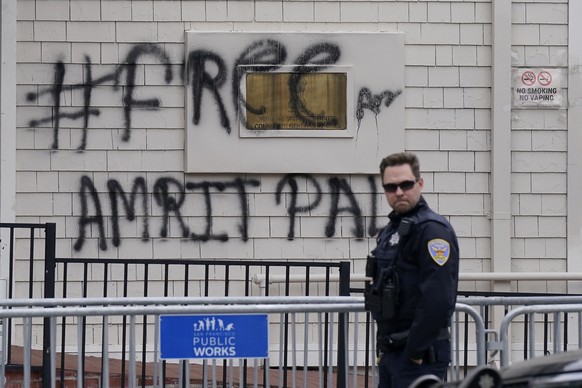 A San Francisco Police Officer stands outside of the entrance to the Consulate General of India in San Francisco, Monday, March 20, 2023. San Francisco police had erected barriers and parked a vehicle ...
