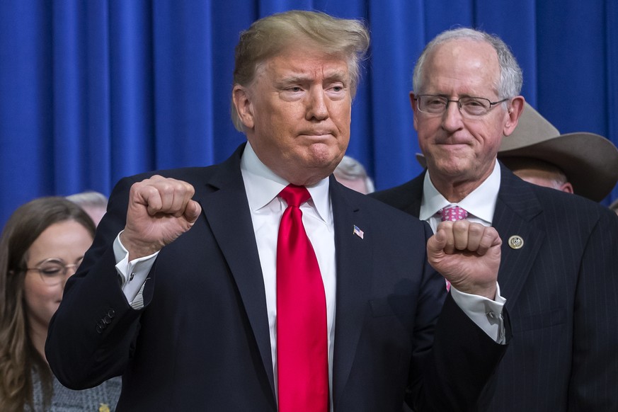 epa07242836 US President Donald J. Trump reacts after signing the Agriculture Improvement Act of 2018 farm bill in the South Court Auditorium of the Eisenhower Executive Office Building on the White H ...