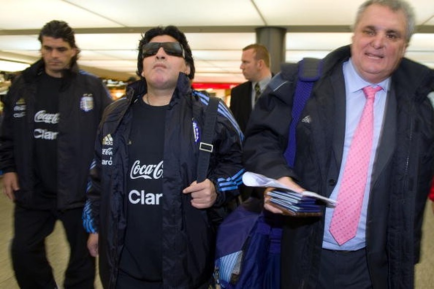 Argentina coach Diego Maradona (L) arrives at Zurich Airport on November 15, 2009 in Zurich. Maradona is to appear for a disciplinary hearing before the world football&#039;s governing body FIFA over  ...