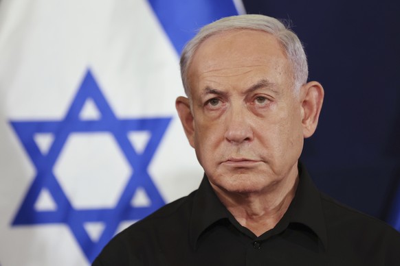 FILE - Israeli Prime Minister Benjamin Netanyahu attends a press conference in the Kirya military base in Tel Aviv, Israel on Oct. 28, 2023. Top Israeli officials are accused of seven war crimes and c ...