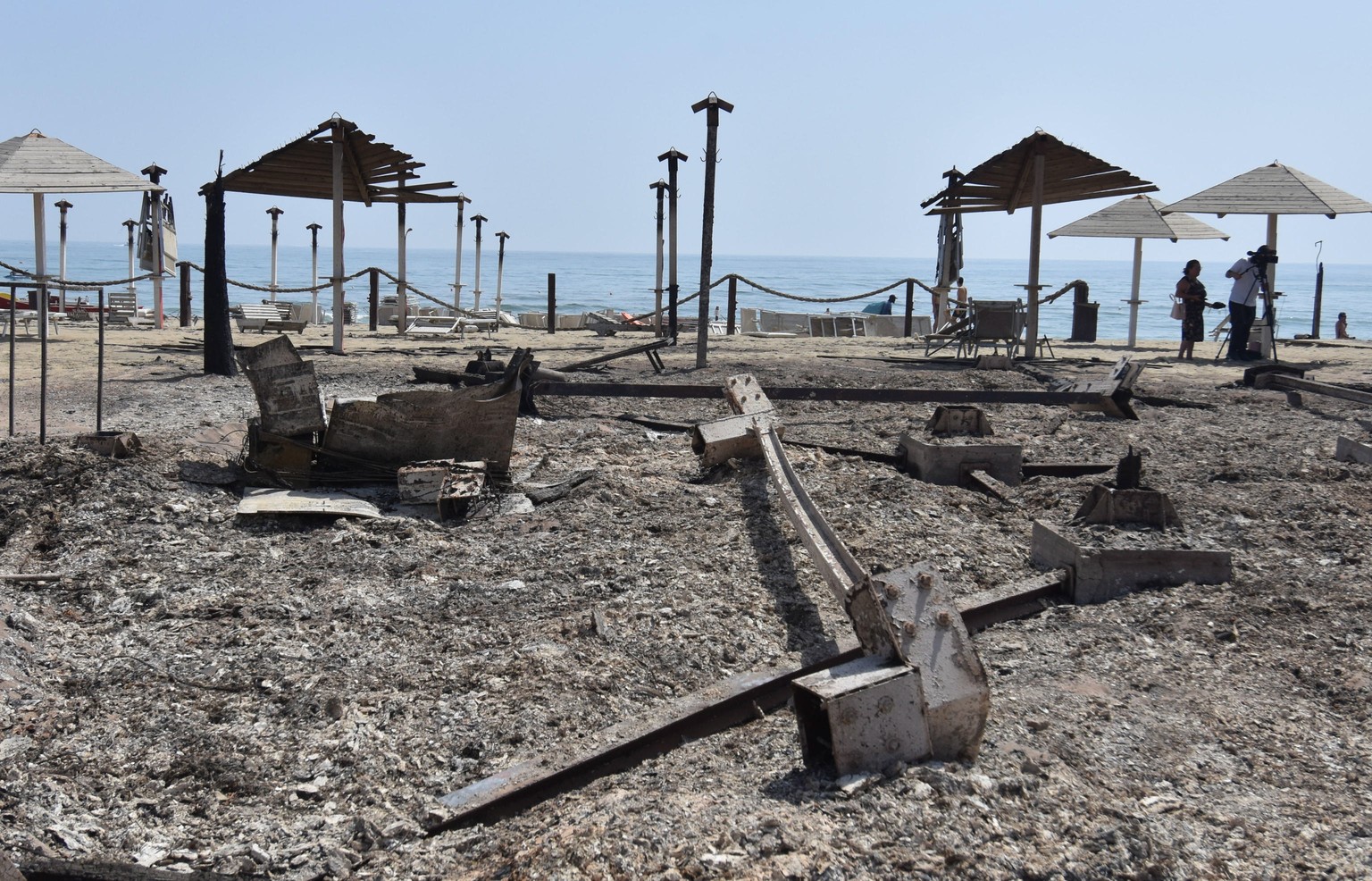 epa09382506 A view of a bathing establishment destroyed by a fire near Catania, Sicily Island, southern Italy, 31 July 2021. A largest number of forest fires are burning in Sicily. Fire brigade teams  ...