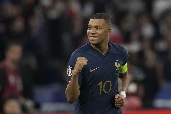 France&#039;s Kylian Mbappe celebrates after scoring the opening goal by a penalty shoot during the Euro 2024 group B qualifying soccer match between France and Greece at the Stade de France, outside  ...