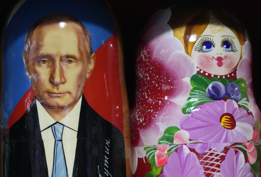A painted Matryoshka doll also known as Russian nesting doll, portraying Russian President Vladimir Putin, stands with others in a souvenir shop in Belgrade&#039;s main pedestrian street, Serbia, Wedn ...