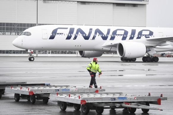 epa08363959 A plane of Finnair carrying special medical face masks and other medical equipments arrives from China to Helsinki-Vantaa airport, Vantaa, Finland, 15 April 2020. Countries around the worl ...