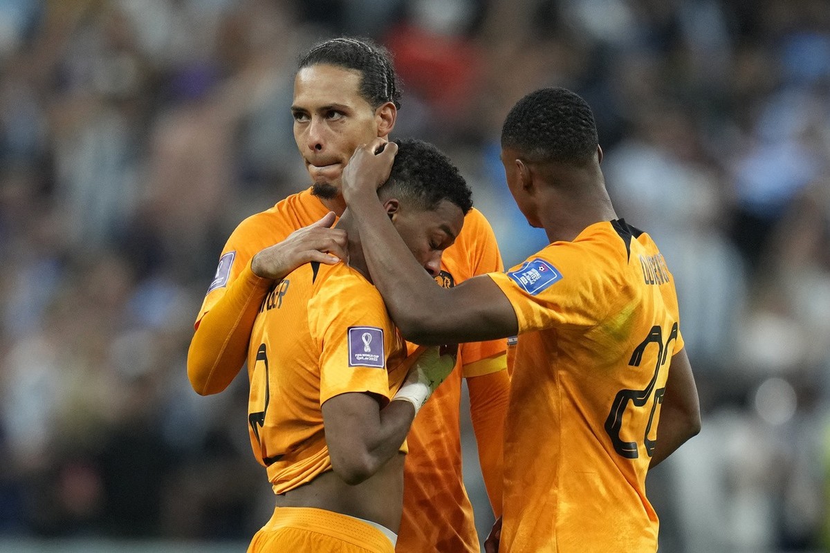 Virgil van Dijk, Jurrien Timber and Denzel Dumfries, of the Netherlands, from left, react at the end of the World Cup quarterfinal soccer match between the Netherlands and Argentina, at the Lusail Sta ...