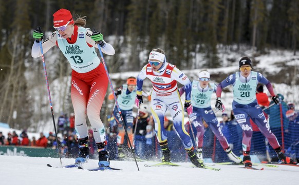 Sweden&#039;s Linn Svahn, middle, skis behind Switzerland&#039;s Nadine Faehndrich (13) during the women&#039;s free sprint at the World Cup cross country skiing event in Canmore, Alberta, Saturday, F ...