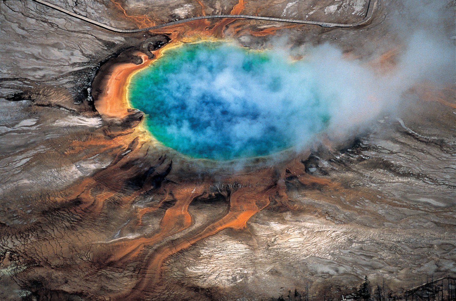 This undated photo provided by Robert B. Smith shows the Grand Prismatic hot spring in Yellowstone National Park's that is among the park's myriad hydrothermal features created by the fact that Yellow ...
