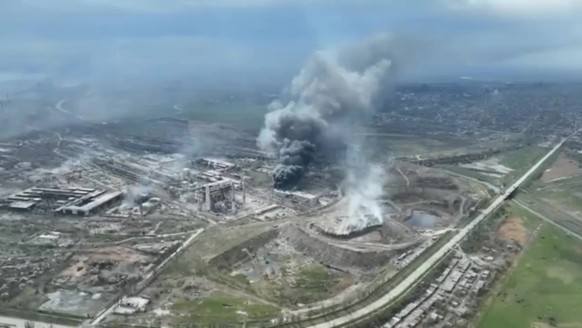 epa09896966 A frame grab from an undated handout drone video first published by DPR militia commander Alexander Khodakovsky and made available by the Mariupol City Council shows smoke rising from the  ...