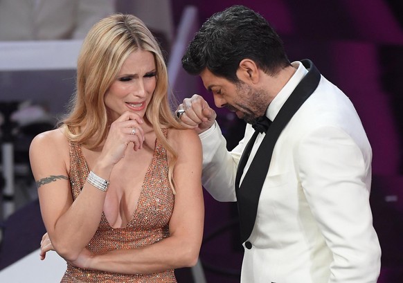 epa06512897 Swiss-Italian TV presenter Michelle Hunziker (L) and Italian actor Pierfrancesco Favino on stage during the 68th Sanremo Italian Song Festival at the Ariston theatre in Sanremo, Italy, 10  ...