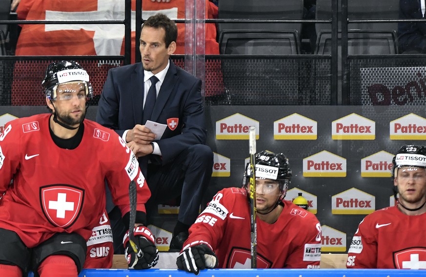 Patrick Fischer, head coach of Switzerland national ice hockey team, left, looks on during their Ice Hockey World Championship group B preliminary round match between Switzerland and Slovenia in Paris ...