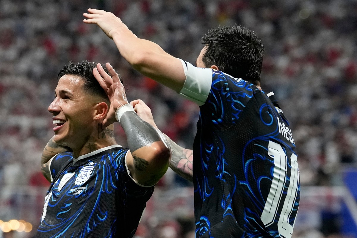 Argentina's Enzo Fernandez celebrates with Lionel Messi, right, after scoring his side's first goal during the World Cup semifinal soccer match between England and Argentina in Atlanta, Wedn ...