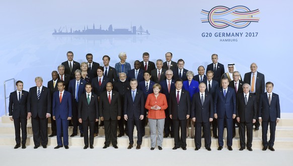 epaselect epa06072710 Heads of state and government of G20 members pose for a family photo at the opening day of the G20 summit in Hamburg, Germany, 07 July 2017. The G20 Summit (or G-20 or Group of Twenty) is an international forum for governments from 20 major economies. The summit is taking place in Hamburg 07 to 08 July 2017.  EPA/CLEMENS BILAN