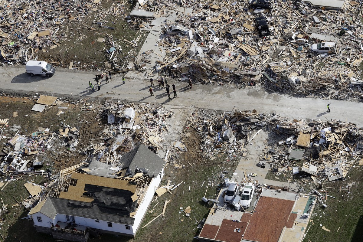 Emergency personnel work among destroyed homes Tuesday, March 3, 2020, near Cookeville, Tenn. Tornadoes ripped across Tennessee early Tuesday, shredding more than 140 buildings and burying people in p ...