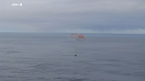 This photo from Axiom Space shows a SpaceX capsule parachuting into the Atlantic Ocean off the coast of Florida on Friday, February 9, 2024.  Astronauts from Turkey, Italy and Sweden returned to Earth…