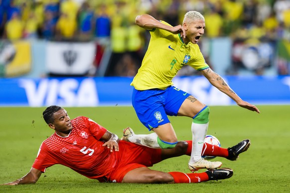 Switzerland's defender Manuel Akanji, left, fights for the ball with Brazil's forward Richarlison, right, during the FIFA World Cup Qatar 2022 group G soccer match between Brazil and Switzer ...