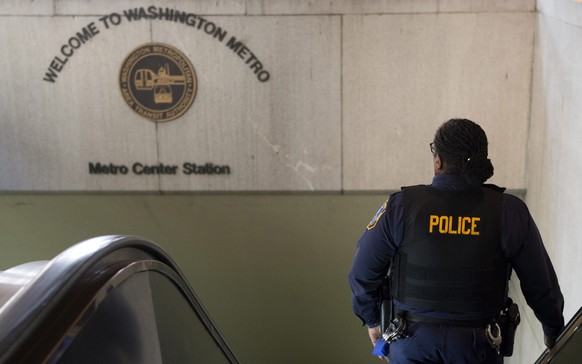 epa05453614 (FILE) A file photo dated 16 March 2016 shows a police officer taking the escalator down to the entrance to Metro Center Metro station in Washington, DC, USA. Reports on 03 August 2016 sta ...