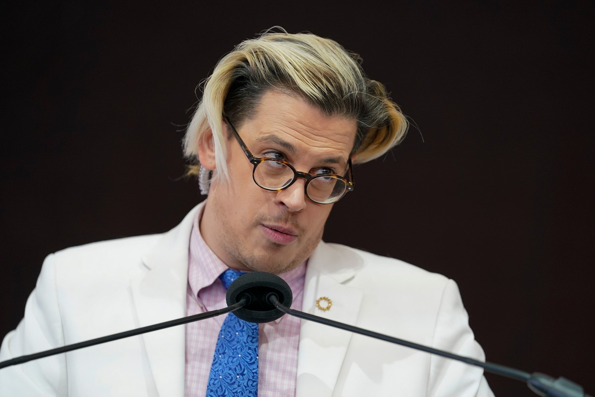FILE - Activist Milo Yiannopoulos speaks during a rally outside of the Baltimore hotel where the United States Conference of Catholic Bishops are holding its Fall General Assembly meeting in Baltimore ...