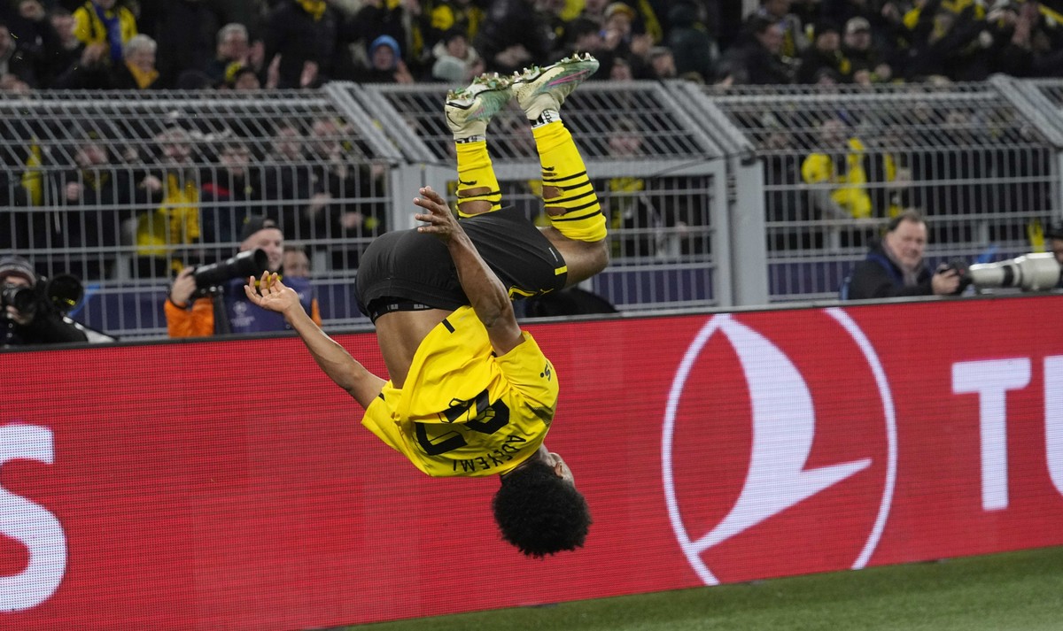 Dortmund's Karim Adeyemi celebrates after scoring his side's first goal during the Champions League, round of 16, first leg soccer match between Borussia Dortmund and Chelsea FC in Dortmund, ...