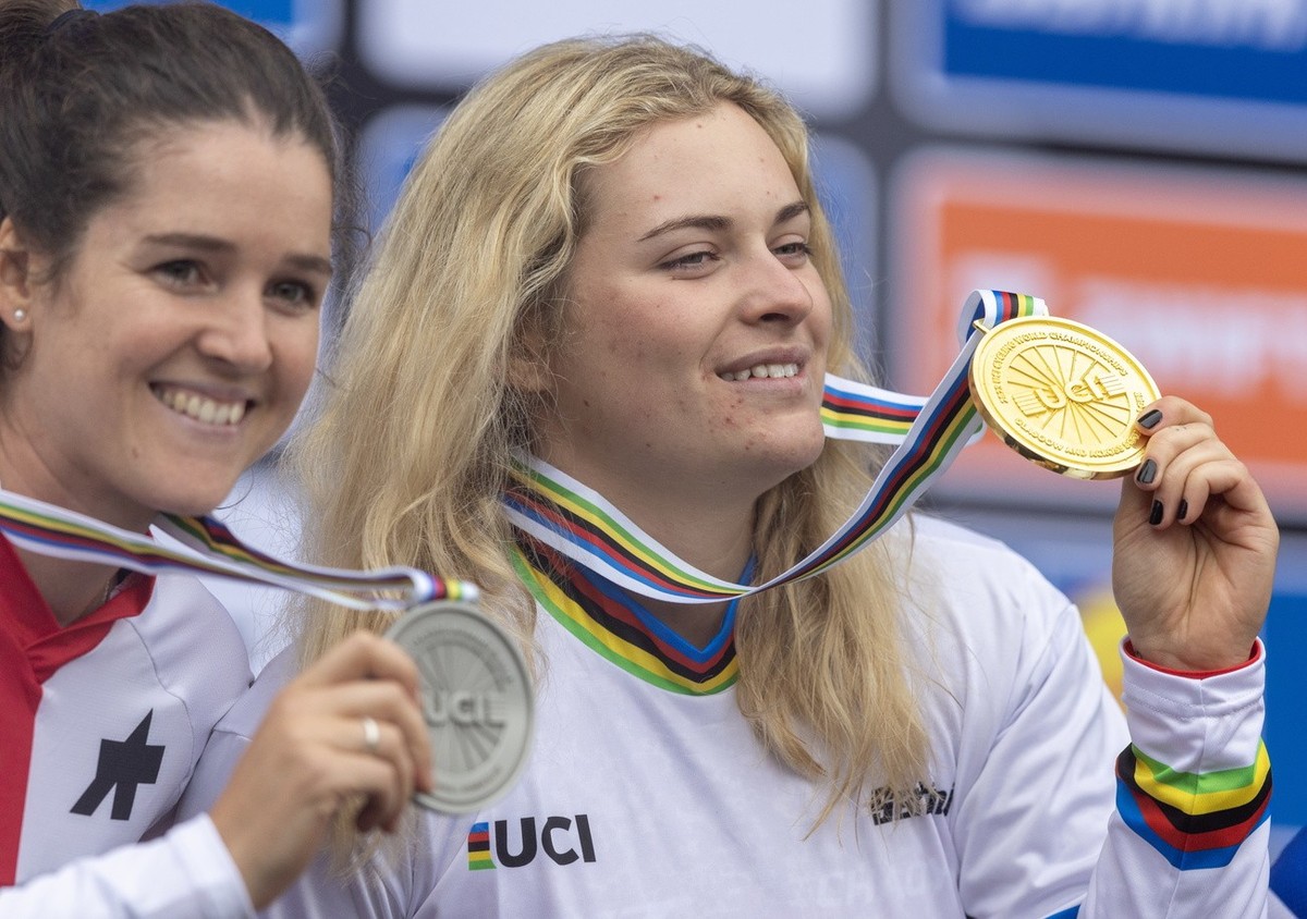 epa10786454 Second placed Camille Balanche (L) from Switzerland and winner Valentina Hoell from Austria celebrate on the podium for the Women's Elite Mountain Bike Downhill event at the UCI Cycli ...