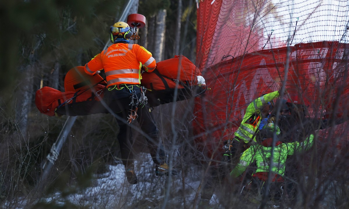 Medical staff are carrying France's Cyprien Sarrazin after crashing into protections net during an alpine ski, men's World Cup downhill training, in Bormio, Italy, Friday, Dec. 27, 2024. (AP ...