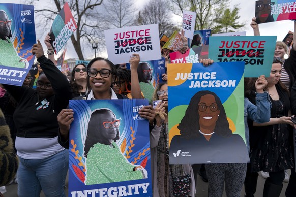 People celebrate the confirmation of Judge Ketanji Brown Jackson, the first Black woman to reach the Supreme Court during a rally outside of the U.S. Supreme Court on Capitol Hill, in Washington, Frid ...