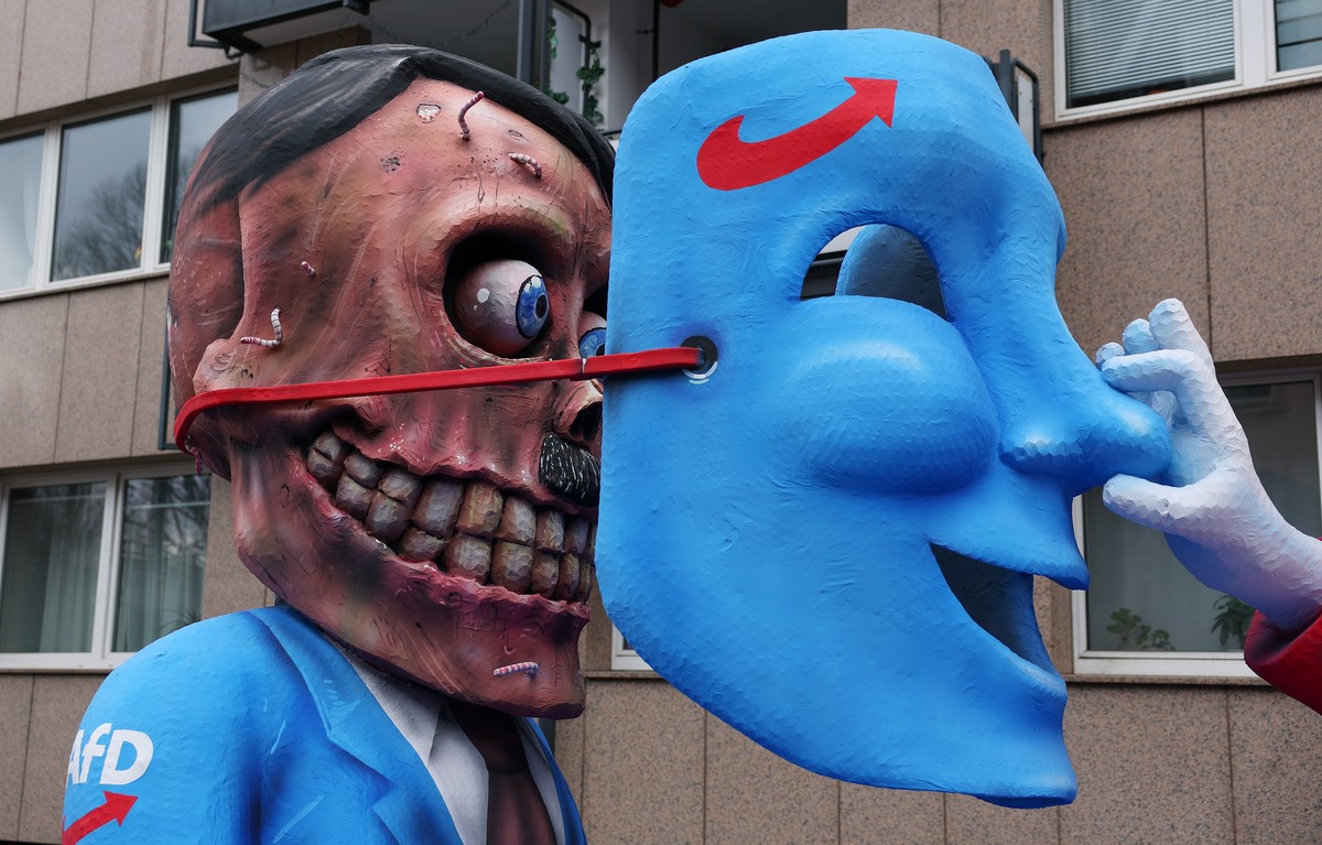 epa11147192 A carnival float depicting a clown lifting a German far-right party Alternative for Germany (AfD) mask from the face of Adolf Hitler is ready for the start of the annual Rose Monday (Rosen ...