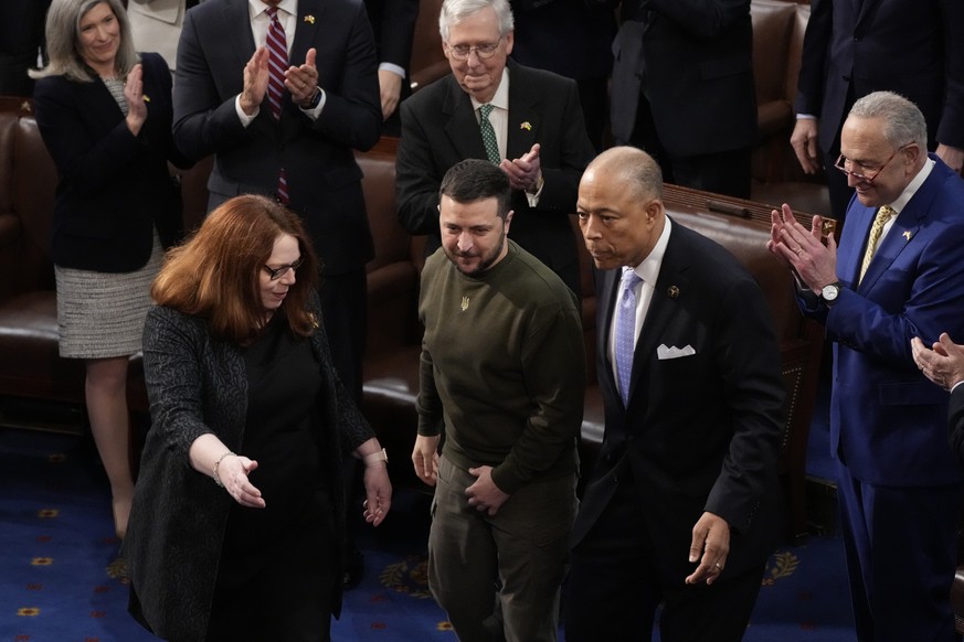 Ukrainian President Volodymyr Zelenskyy arrives and is escorted to the podium before addressing Congress during his first trip outside his country since Russia invaded in February, at the Capitol in W ...