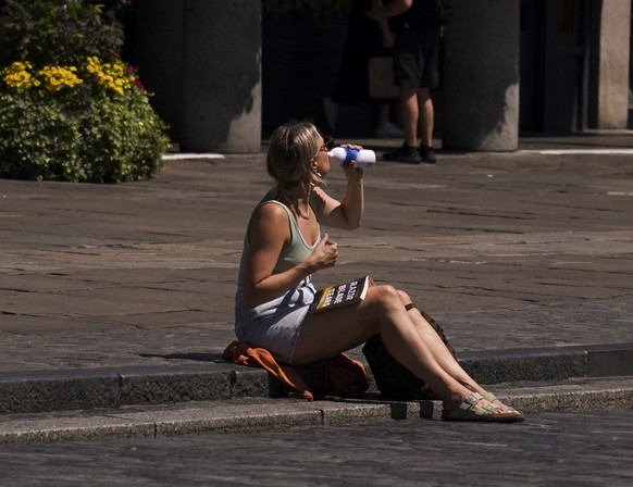 A woman takes a drink during hot weather in Covent Garden, in London, Monday, June 30, 2025. (AP Photo/Alberto Pezzali)
Britain Extreme Weather Heat