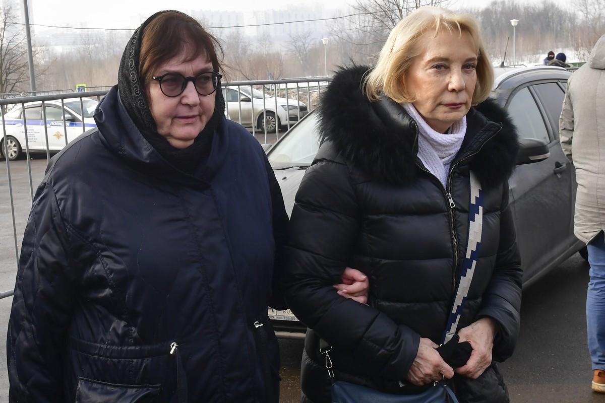 Russian opposition leader Alexei Navalny's mother, Lyudmila Navalnaya, left, and his mother-in-law, no name available, arrive to visit the grave of Alexei Navalny after his funeral yesterday at t ...